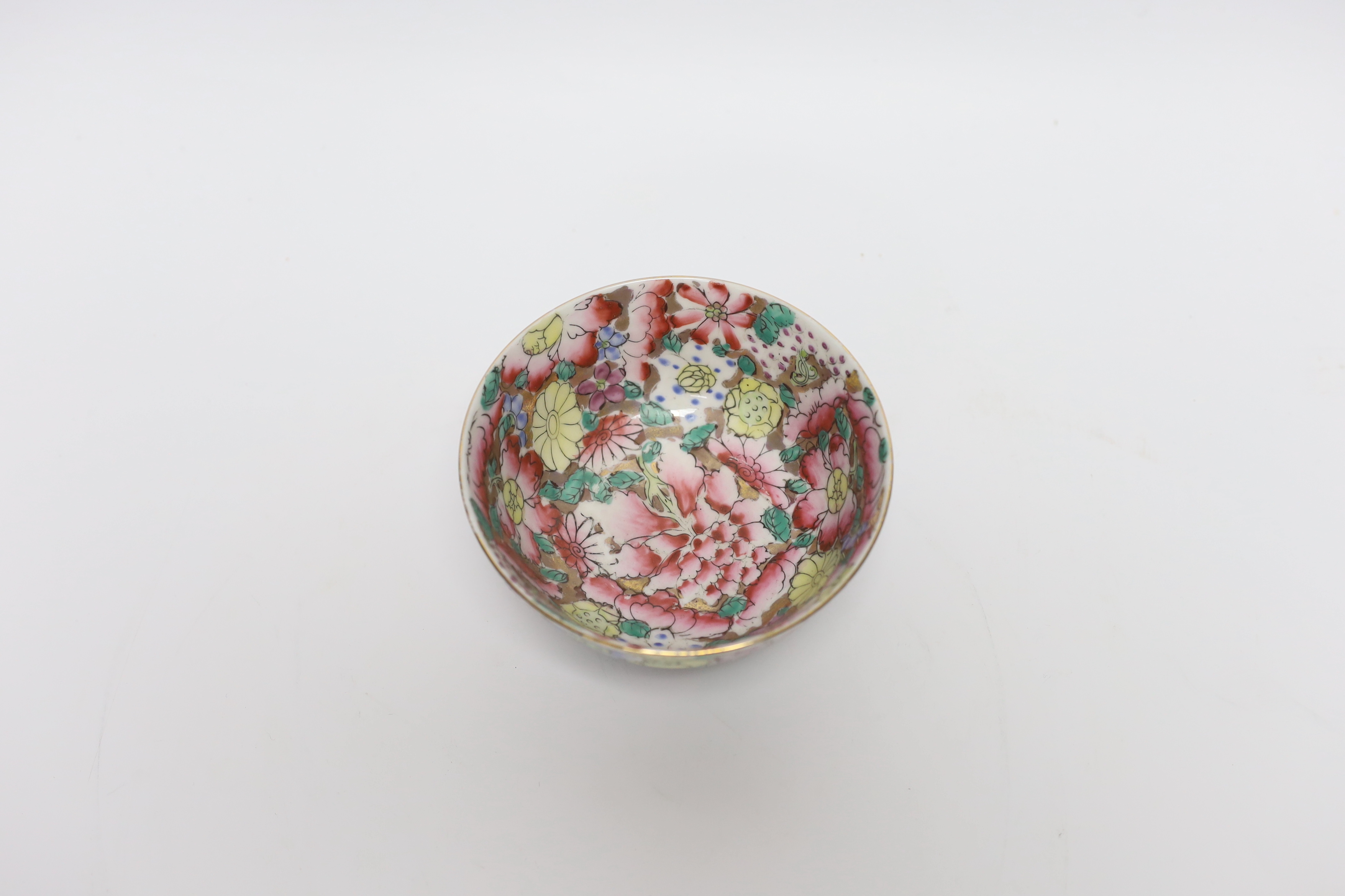 A small circular Chinese porcelain bowl having polychrome 'millefiore' and gilt decoration, diameter 11.5cm, red seal mark to base